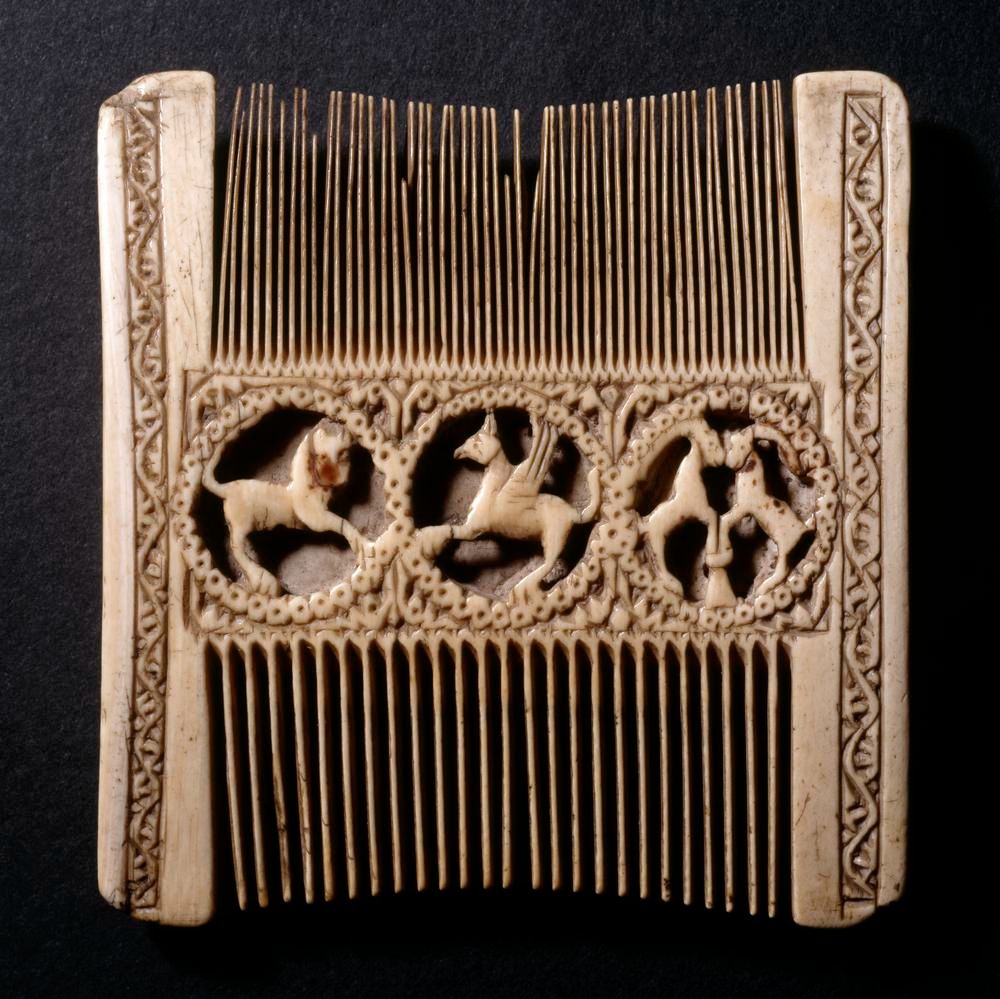 Photo of a late mediaeval ivory comb with elaborate decorations in the form of wild animals.
(c) Trustees of the British Museum