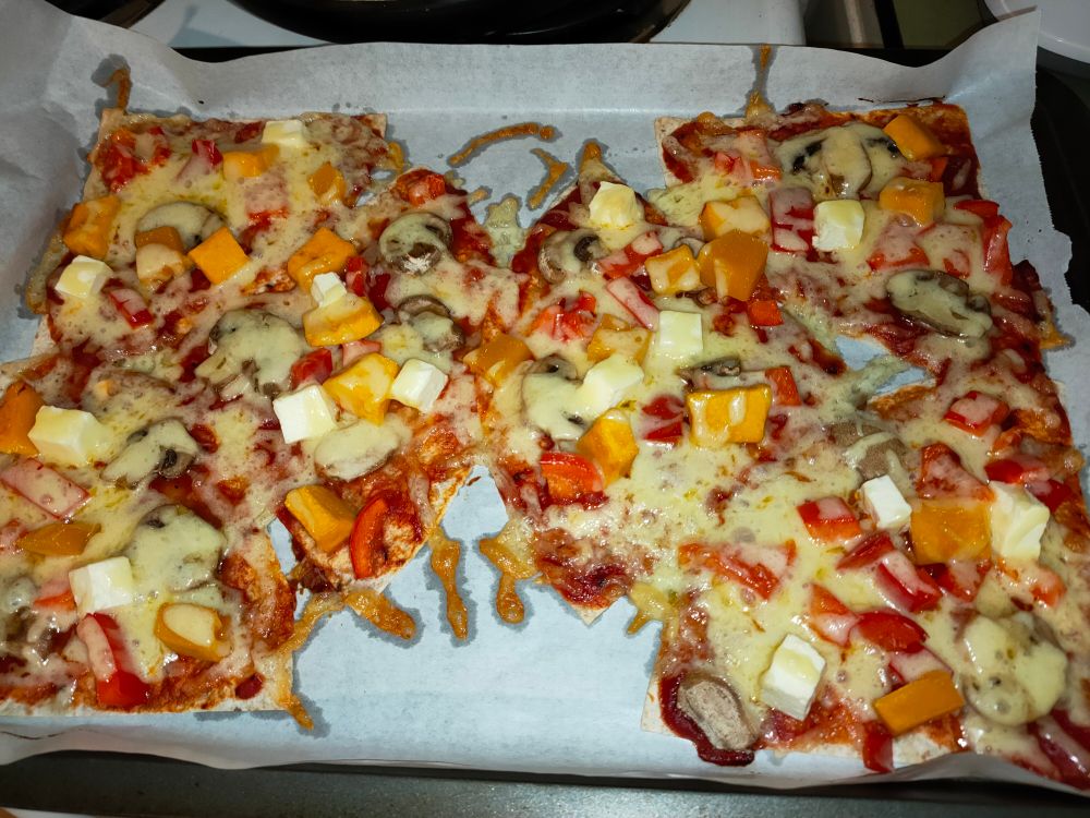 Homemade pizza fresh out of the oven. It mostly looks like a giant mess.