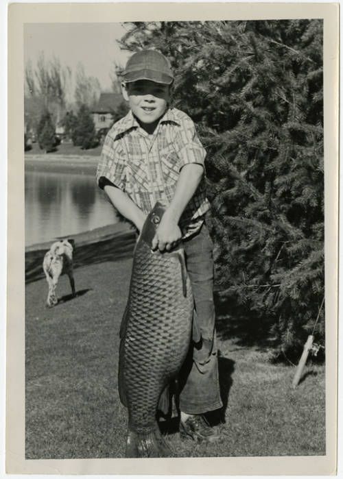 young kid with very large fish