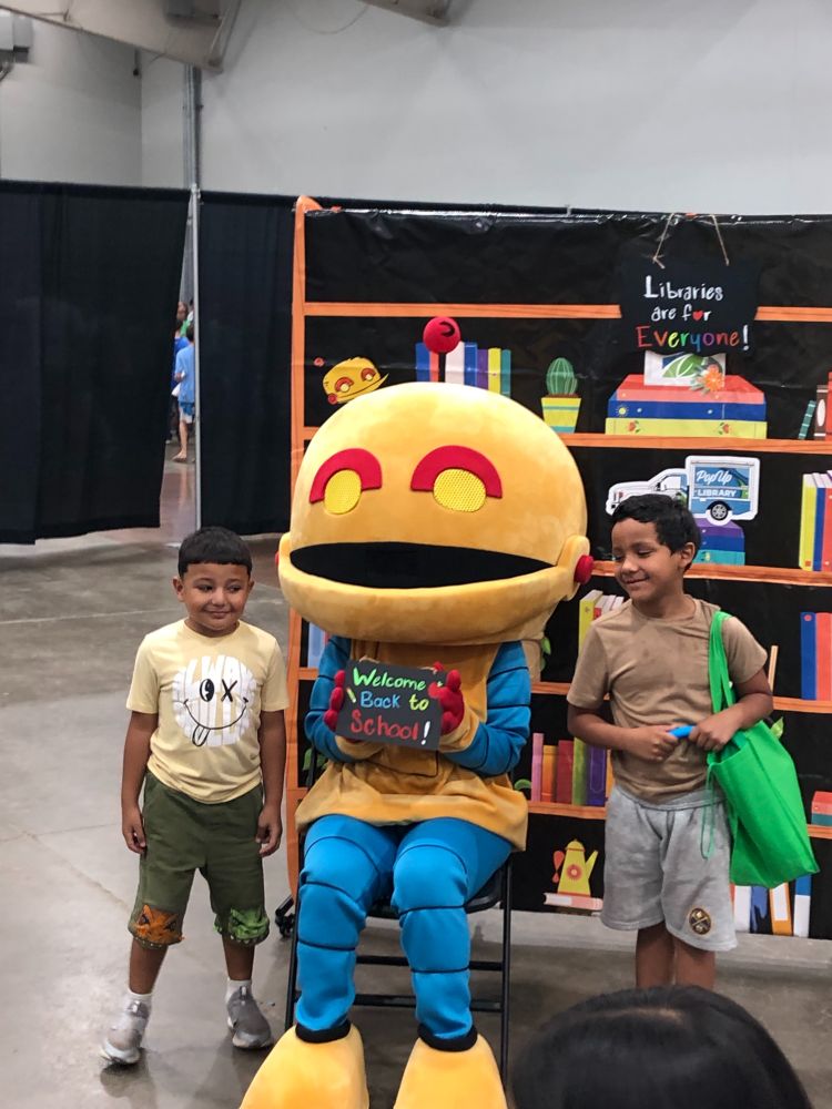 kids with yesbot mascot