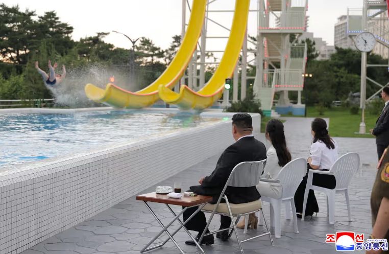 Kim Jong-un observes a human being who appears to be being launched off the end of a water slide in a new beach resort in North Korea