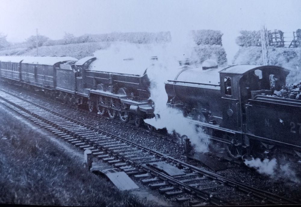 North of Berwick, at the station at Reston, an NBR 0-6-0 No. 174 helps out NER 4-6-2 No. 2400 on an East Coast express in the inaugural year of the grouping, 1923.
