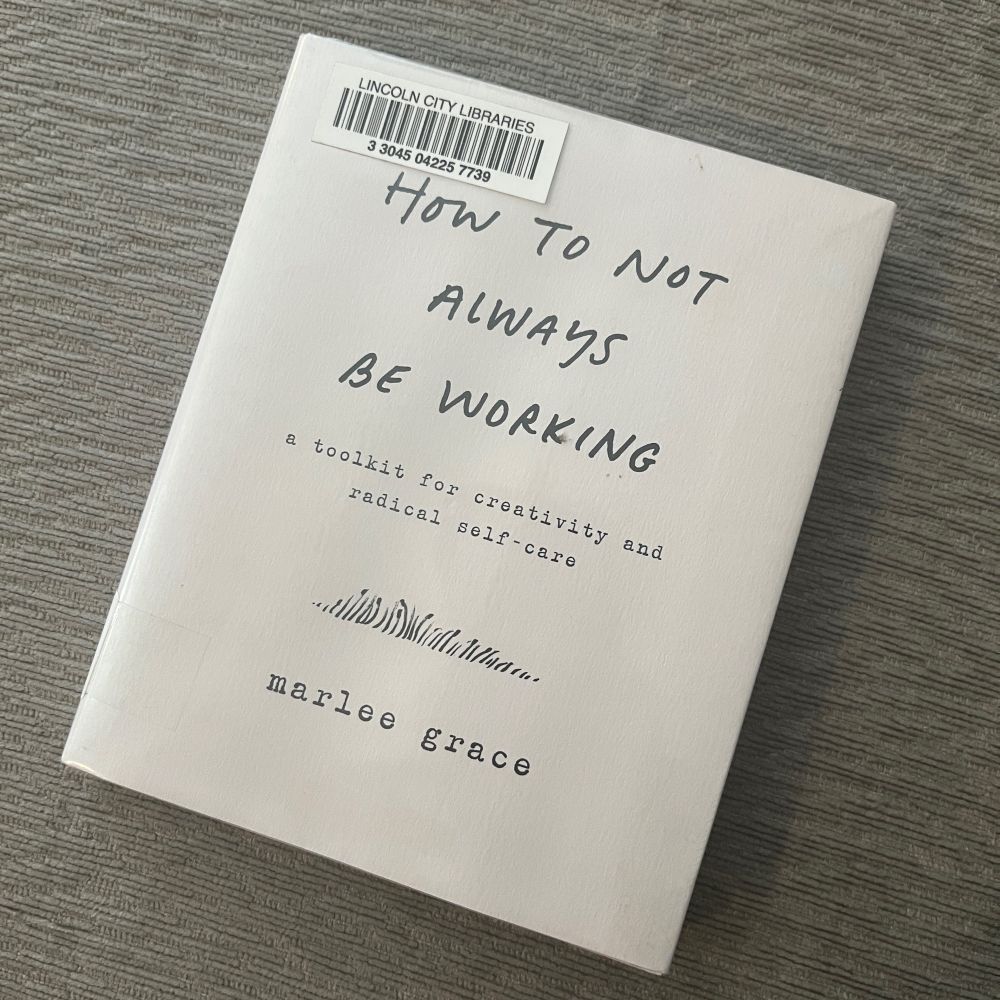 The book How to Not Always Be Working: a toolkit for creativity and radical self-care by Marlee Grace on a gray background