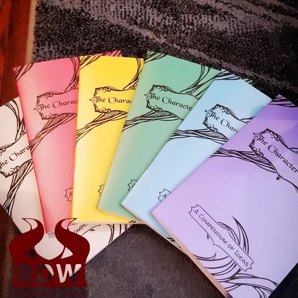 6 fanned out booklets of "the Character Archive" in metallic rainbow colours
