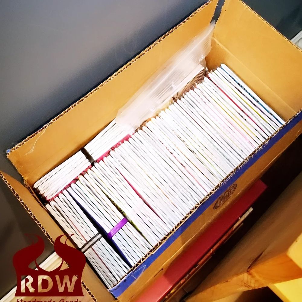 A long box filled fully the hamdmade booklets of "the Character Archive" ready for August cons 