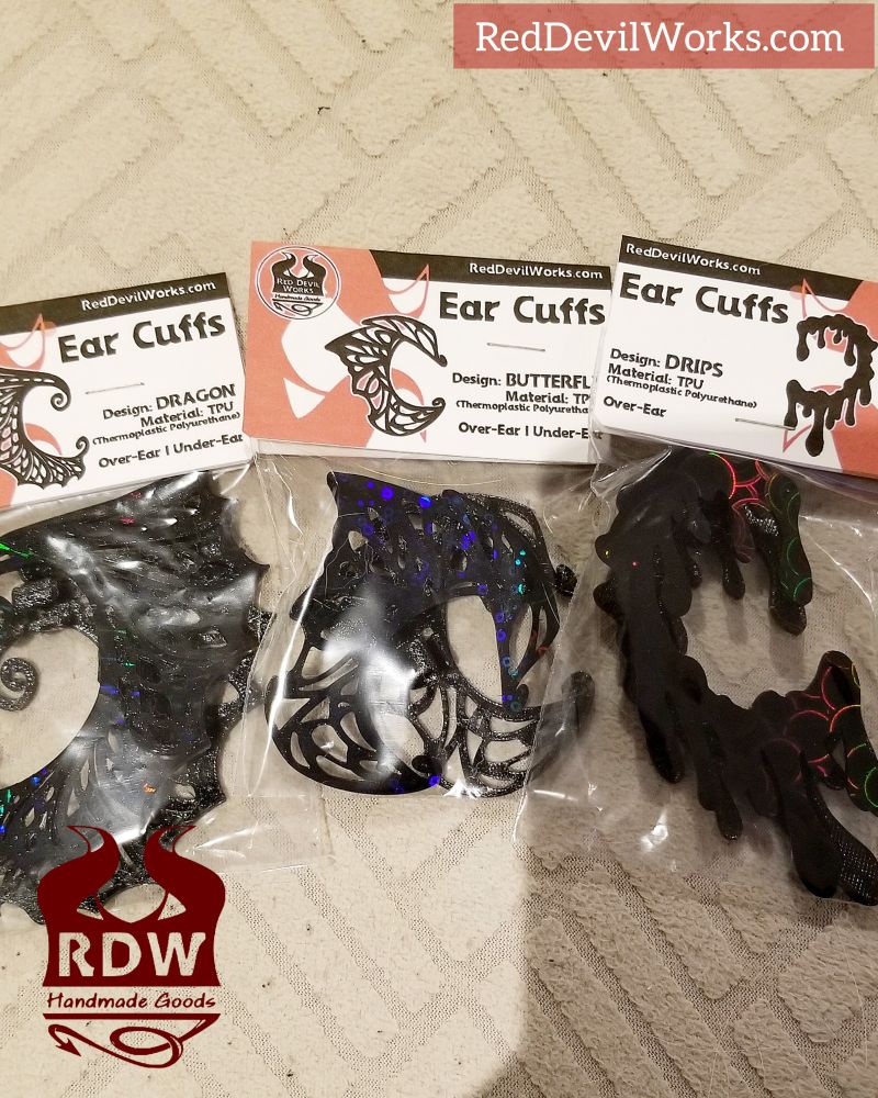 3 designs in black from Red Devil Works new lineup of ear cuffs. Packaged nicely in bags and labels. The designs read: Dragon, Butterfly and Drips