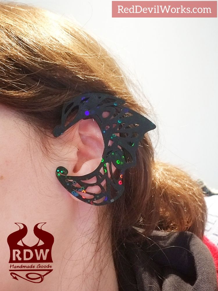 A woman wearing a black butterfly design ear cuff by Red Devil Works 