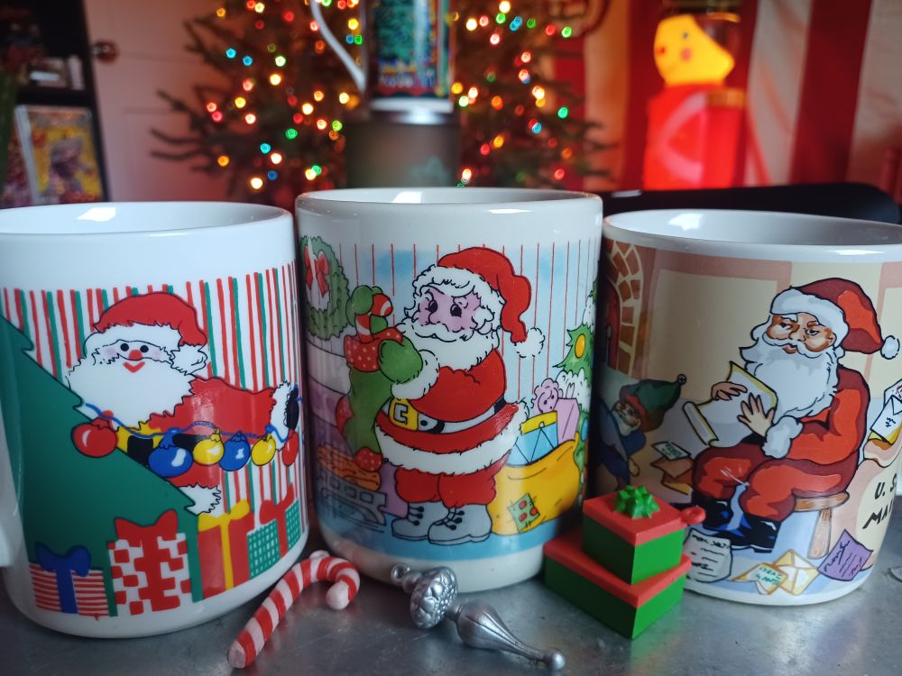 3 Santa mugs: Vintage Hong Kong Santa decorating a tree, a grumpy pink Santa stuffing a stocking, VERY grumpy Santa checking his naughty or nice list