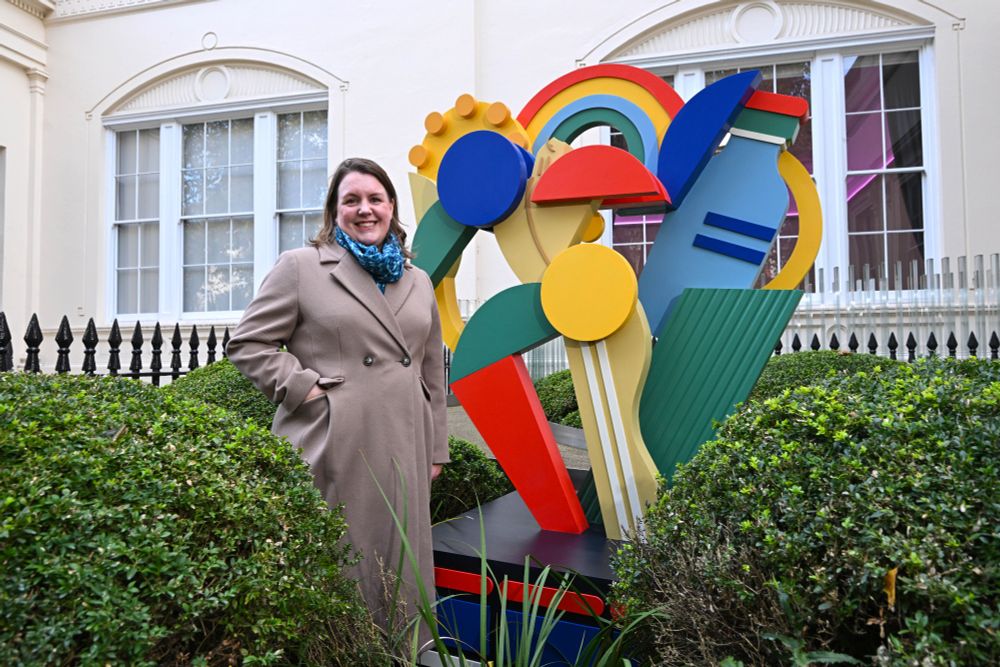 Picture of Alice Kan stood outside the Royal Academy of Engineering alongside a statue made for her in honour of National Engineering Day
