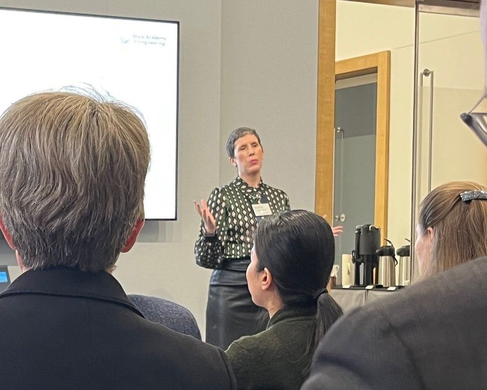 Natasha McCarthy, Associate Director of Policy at the Academy, standing at the front of a room presenting in front of people.