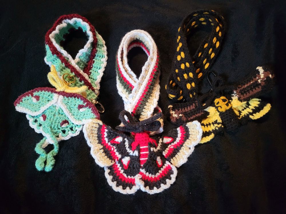 Left: crocheted matching luna moth plush and lanyard
Middle: crocheted matching cecropia moth plush and lanyard
Right: crocheted matching deaths head hawkmoth plush and lanyard