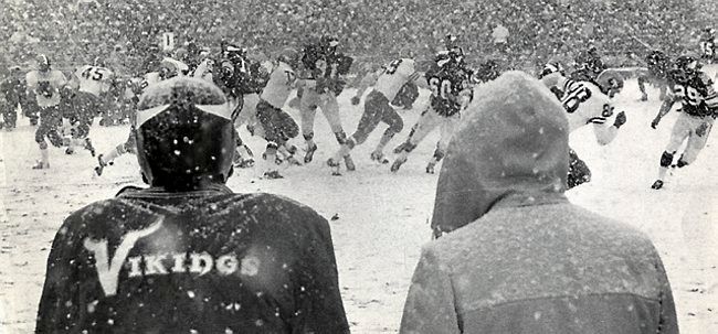 Black and white photo of Minnesota Vikings playing the SF 49ers in a LOT of snow, while coach Bud Grant looks on.