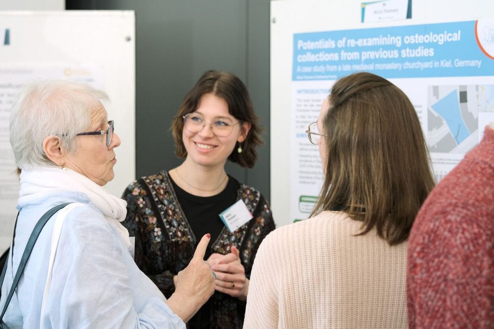 A group of women standing around a poster