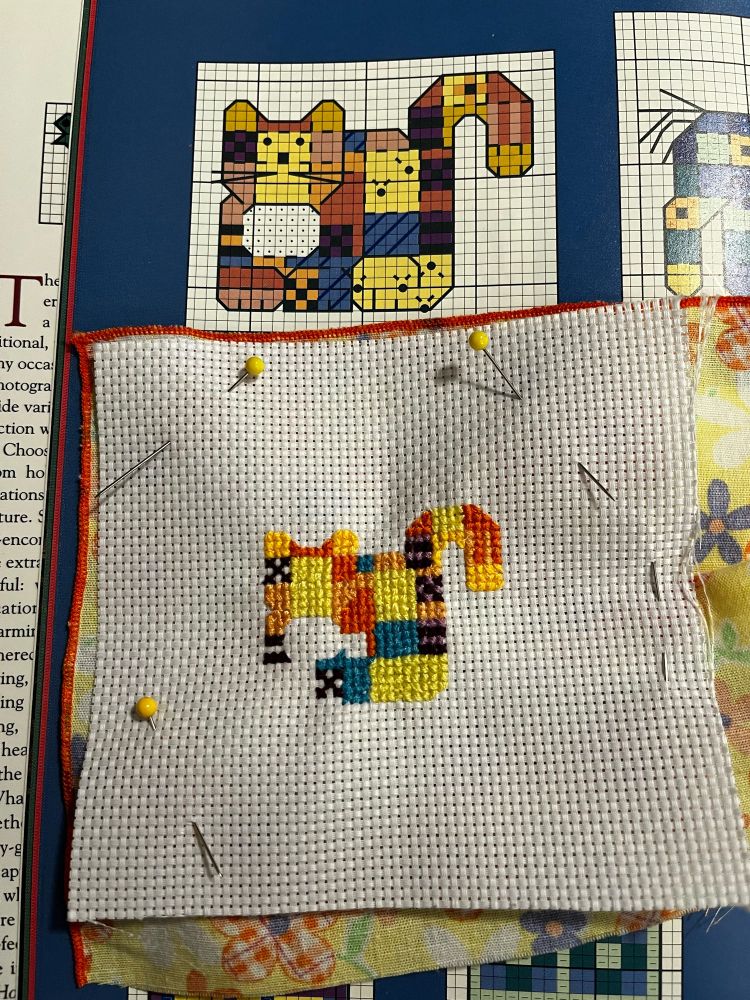 Quilt top patterned cat, that is in the middle of being cross stitched
#embroidery #textileart 