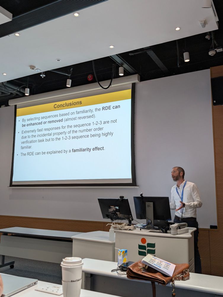 Presenter Francesco Sella next to his conclusion slide