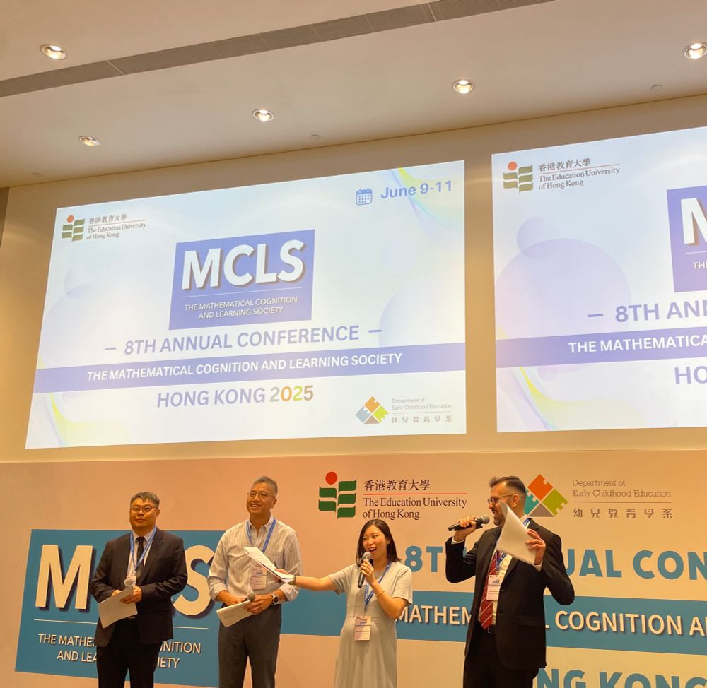 MCLS 2025 organizing committee standing in front of MCLS 2025 welcome slides