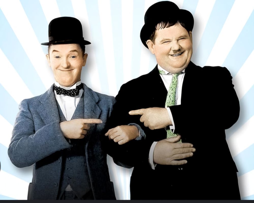 A picture of comedy duo Laurel and Hardy pointing at each other.