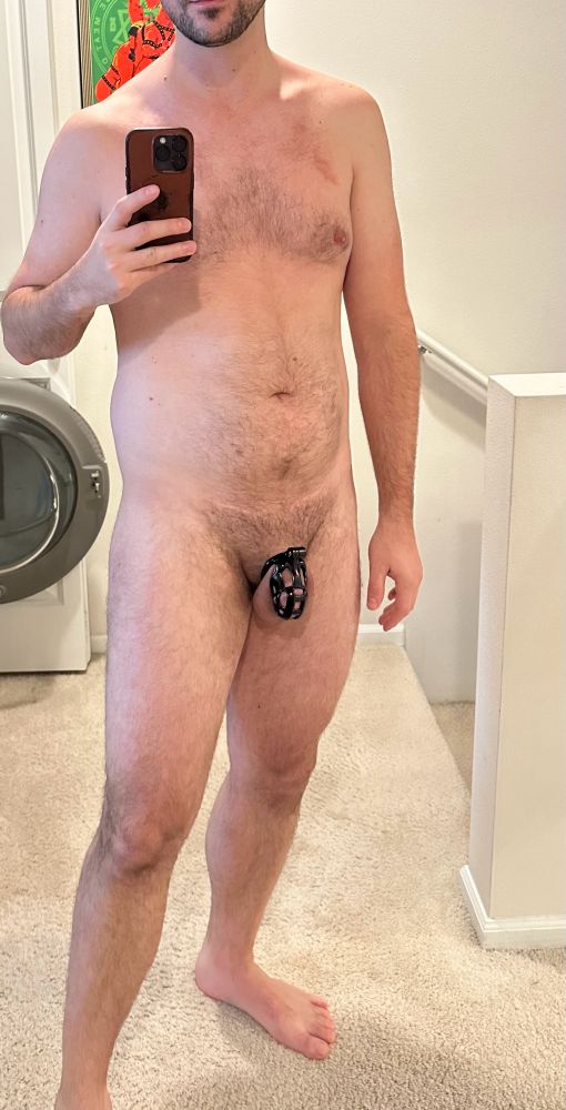 Naked man wearing chastity cage