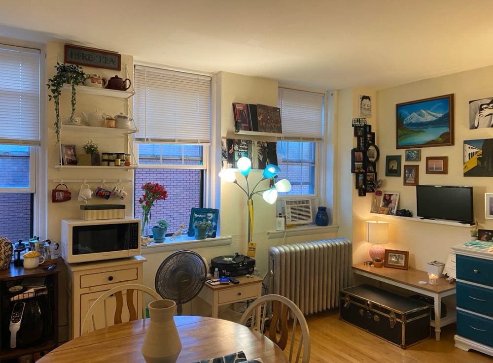 the same apartment, more decorated, still a bare floor and empty table. 