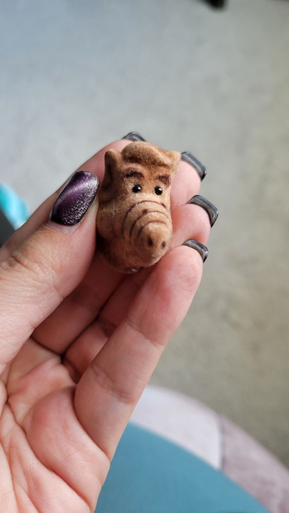 A 3D fuzzy Alf head pin. 