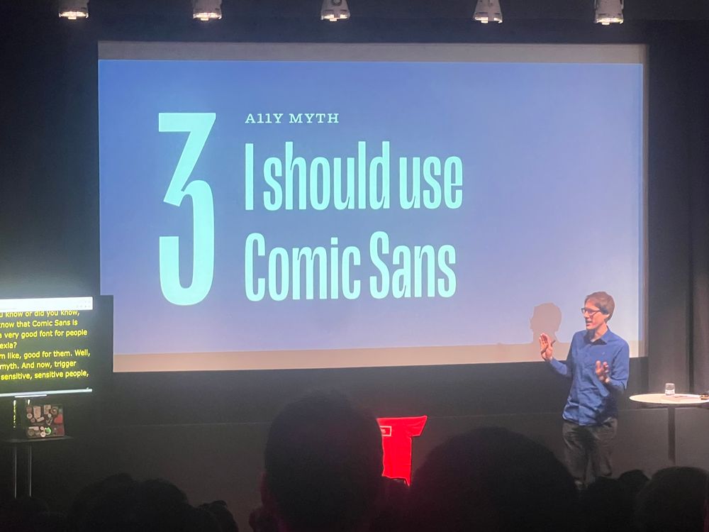 Oliver Schöndorfer on stage at State of the Browser conference in front of a slide that reads ‘A11Y myth: I should use Comic Sans’