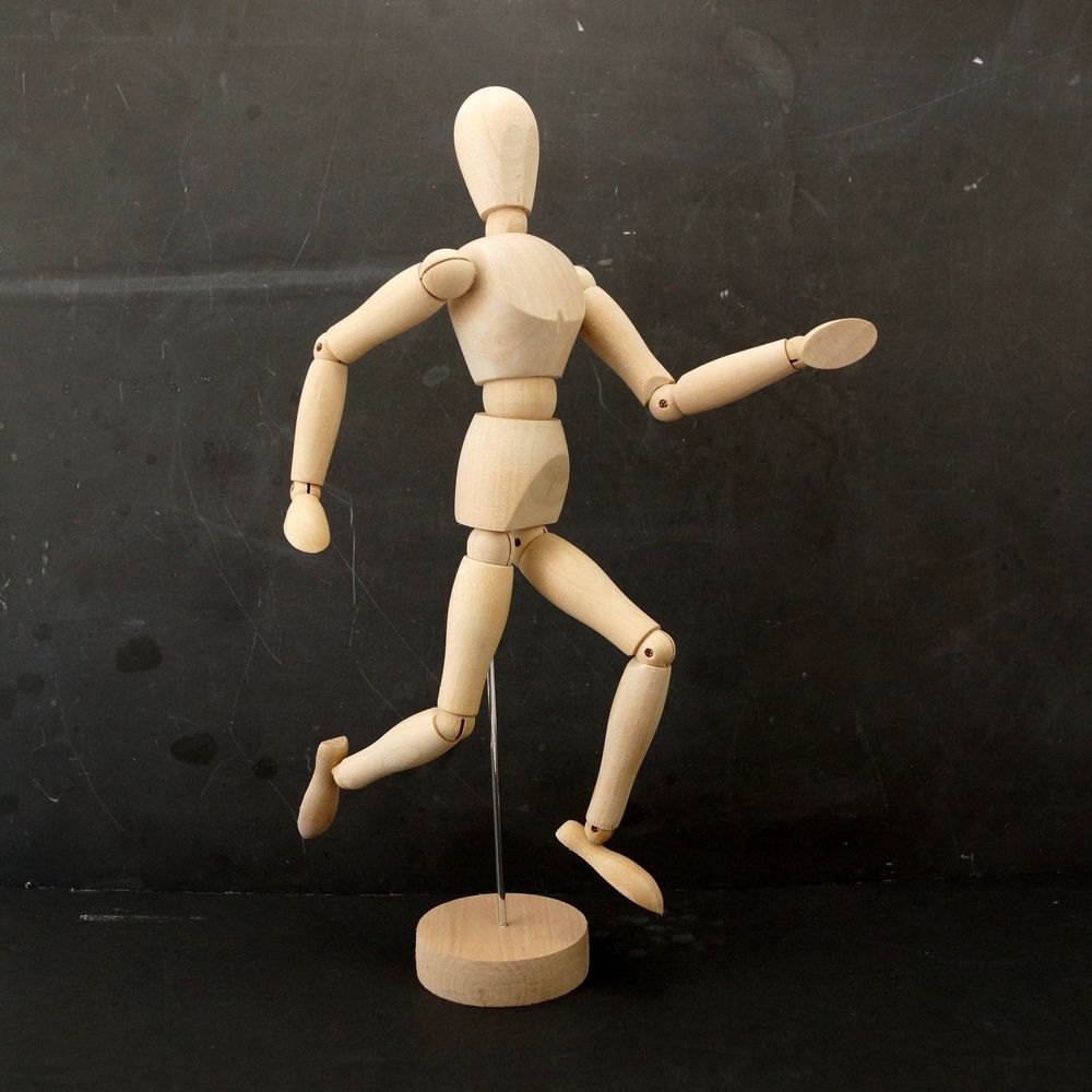 A wooden artist's mannequin, set into a running pose.
Taken from Third Shift Vintage dot com.