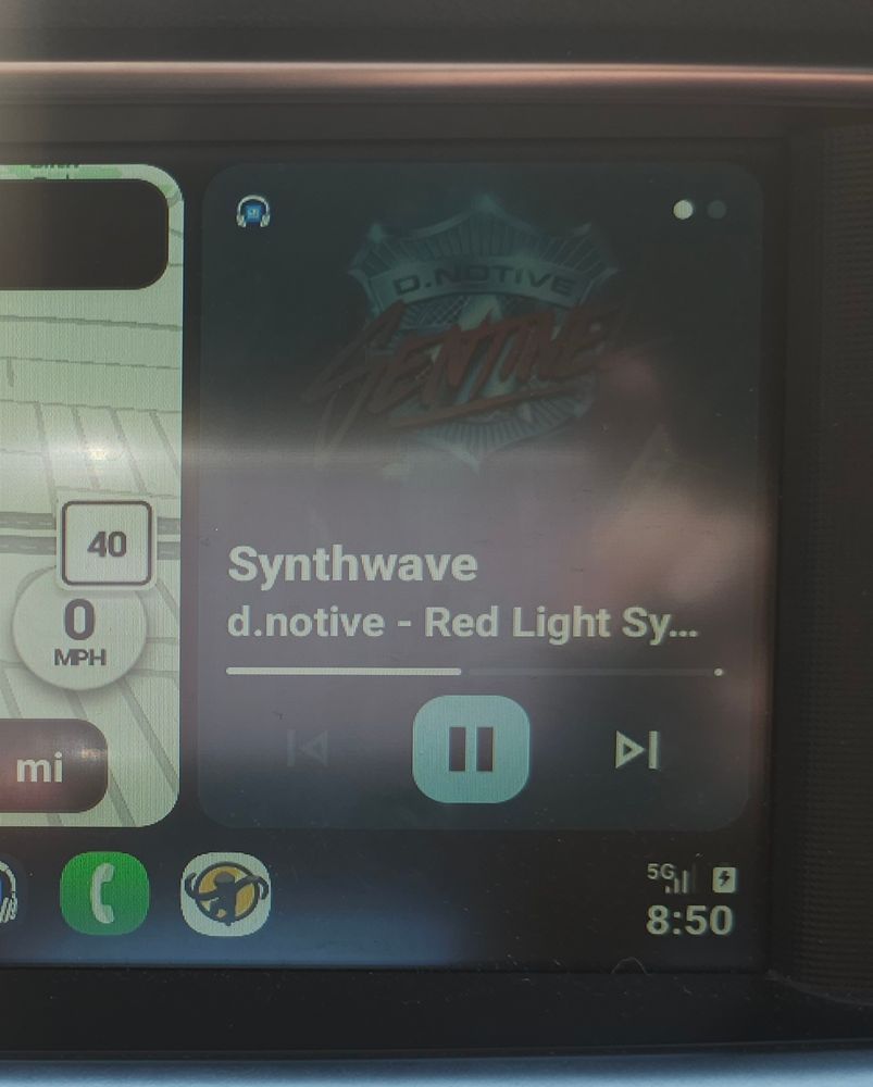 Photo of car display showing Synthwave channel on di.fm playing d.notive. Also shows the car is stopped.