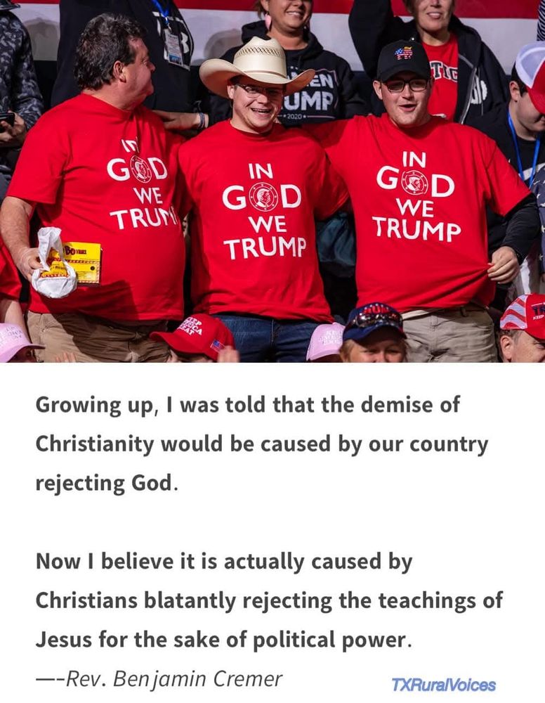 People wearing T-shirts saying "In God We Trump"