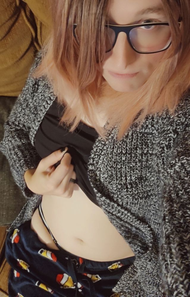 Transgirl in pj's and a wool sweater, pulling up her shirt to show her tummy and thighs absolutely consuming her panties.