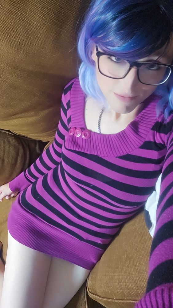V in a purple and black striped sweater and nothing else.