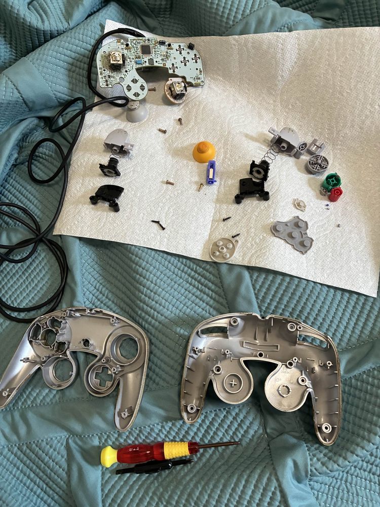 a silver gamecube controller that has been disassembled