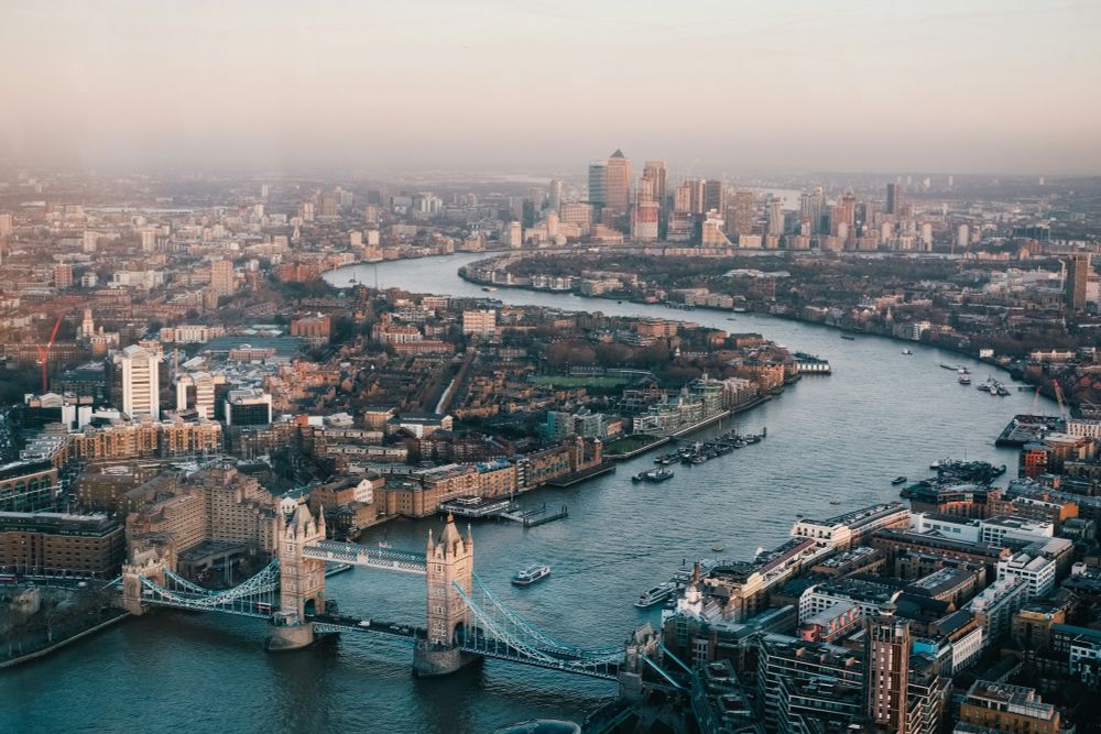 Aerial view of Tower Bridge, crossing the River Thames in London with hazy city skyline