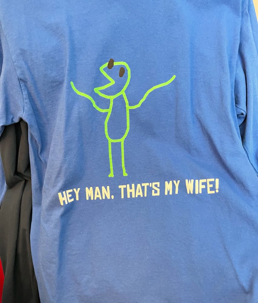 blue long sleeve shirt with a stick figure drawing of kermit the frog. the caption reads “Hey man, that’s my wife!”