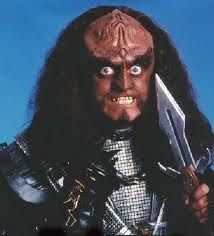 Gowron, from Star Trek. He's doing crazy eyes into the camera and brandishing a Klingon knife.