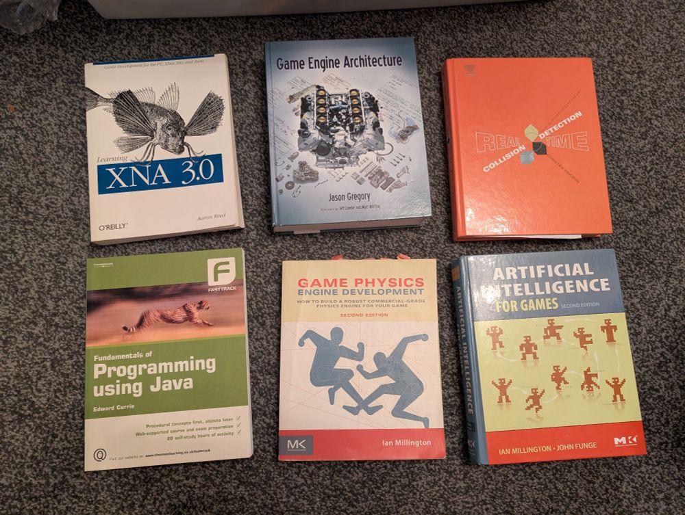 A collection of 6 game development books from 2009ish. Learning XNA 3.0, Game Engine Architecture, Real Time Commission Detection, Fundamentals of Programming using Java, Game Physics Engine Development, and Artificial Intelligence for Games. 

the top of the XNA book says "Game development for the PC, Xbox 360 and Zune."

ZUNE.