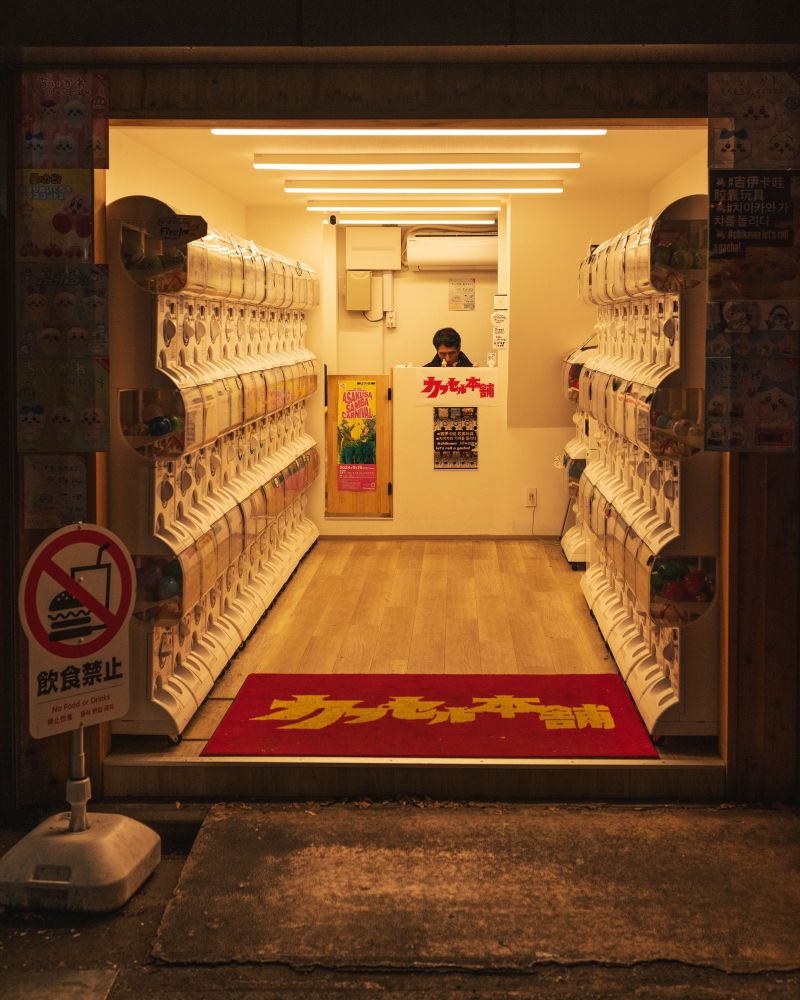 A capsule dispenser merchant behind the counter in his shop at Kyoto, Japan.

Photographed by DD Chu.