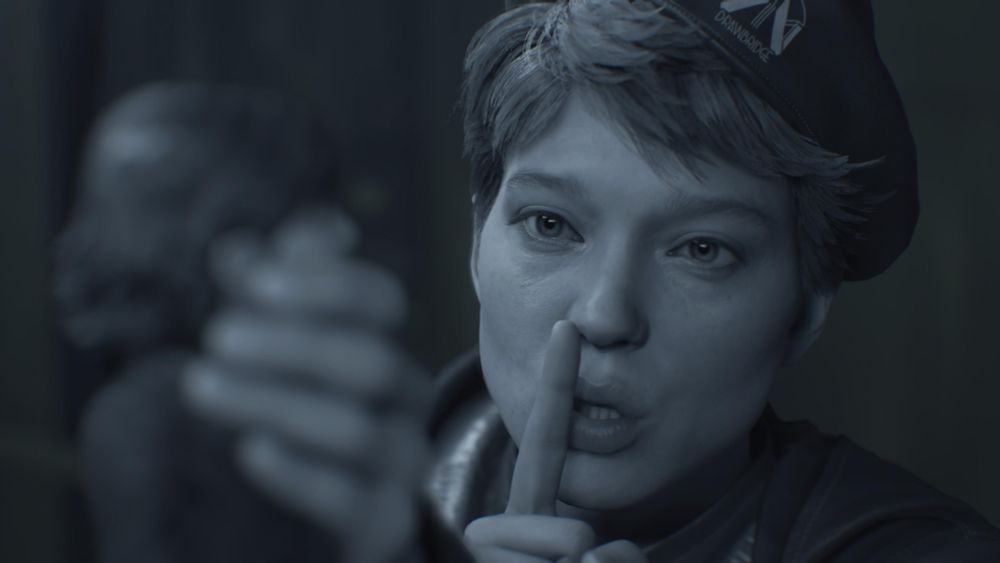 Death Stranding 2 photo of Fragile shushing someone. The image is black and white