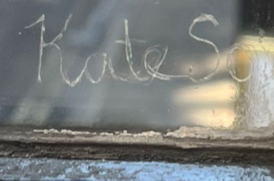 Kate So written on the window 