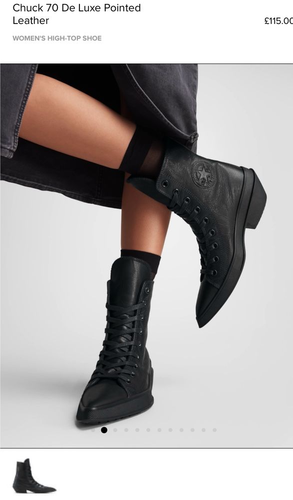Picture of a woman’s feet wearing black high top converse with long pointed toes