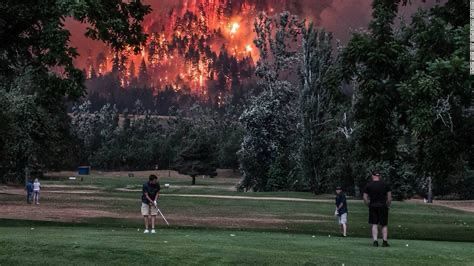 Golfers continuing their game while forest fires rage in the background. https://edition.cnn.com/2017/09/07/us/golf-wildfire-trnd/index.html