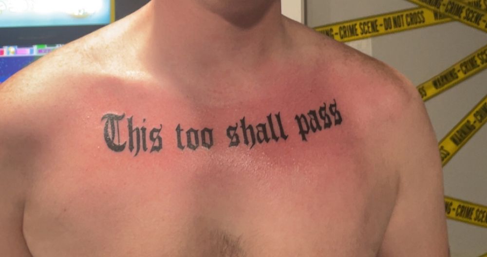 Tattoo on chest says This too shall pass 