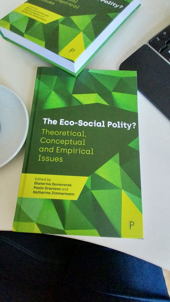 Hardcopy of the book "The eco-social polity?" on a desk