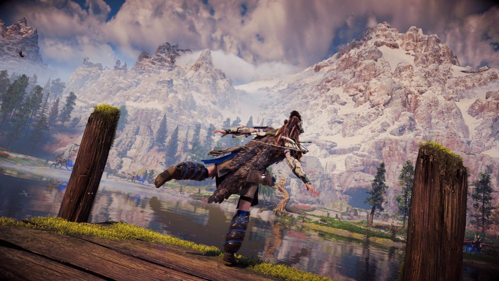 Aloy balances on her right leg at the edge of a mountain pond.