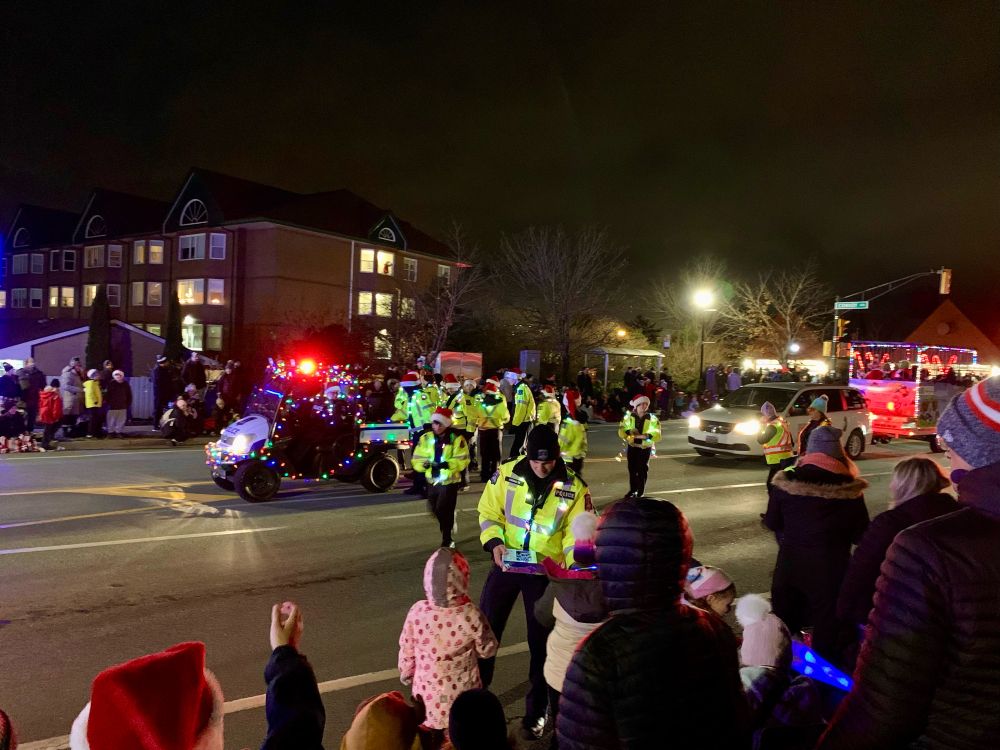Parade participants handing out candy canes to kids at the Bedford Parade in Nova Scotia Canada