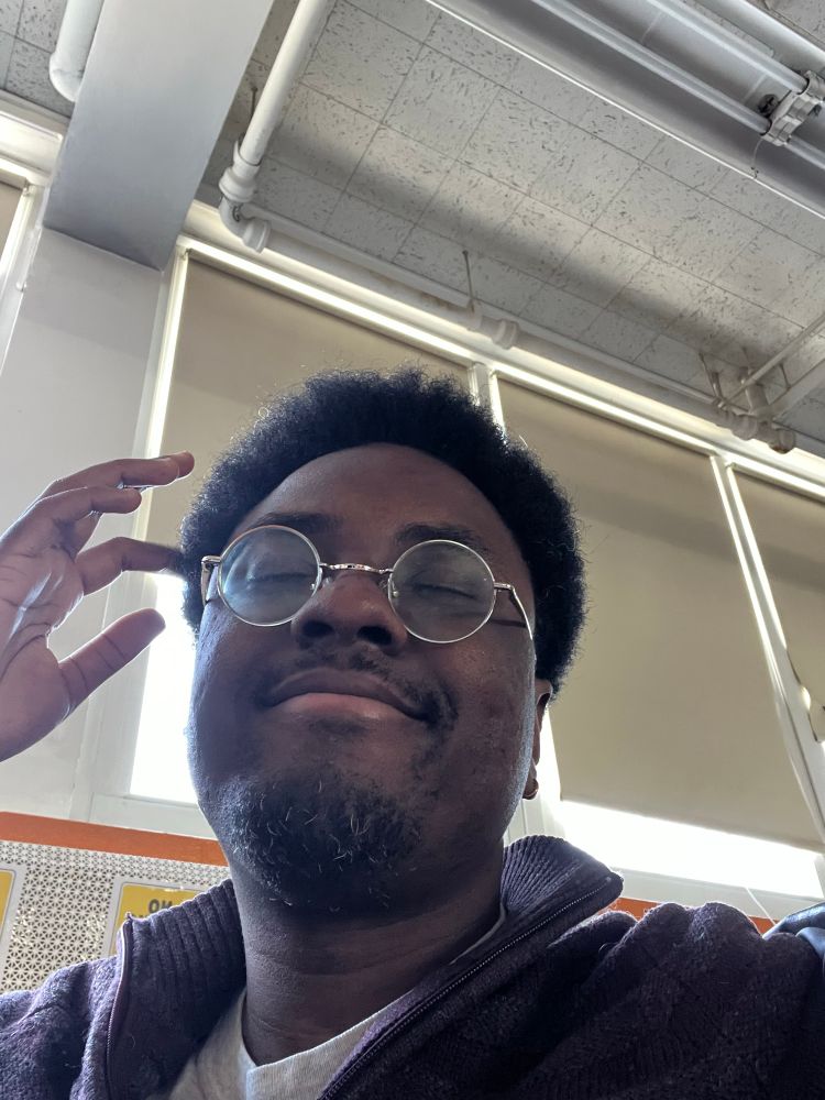 Me with a weird little smile and my eyes fully closed and the daylight shining down into the basement