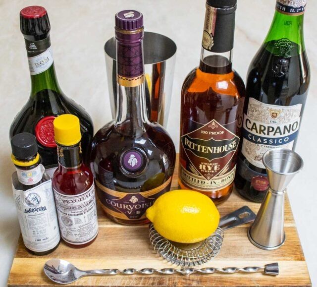The ingredients of a Vieux Carre, displayed on a serving board with bar tools: angostura bitters, peychaud bitters, Benedictine, cognac (Courvoisier), rye (Rittenhouse), and sweet vermouth (Carpano). And a lemon.
3/4 oz rye
3/4 oz cognac/brandy
3/4 oz sweet vermouth
bar spoon Benedictine 
2-3 dashes Peychaud bitters
2-3 dashes Angostura bitters

Build ingredients in a mixing glass over ice. Stir until thoroughly chilled. Pour into a conveniently suitable glass unless you feel fancy, neat or over a big block of ice. Garnish with lemon peel or a brandy cherry, or, you know, just drink the damn thing in front of a nice fire and/or with a good book or drinking buddy.
