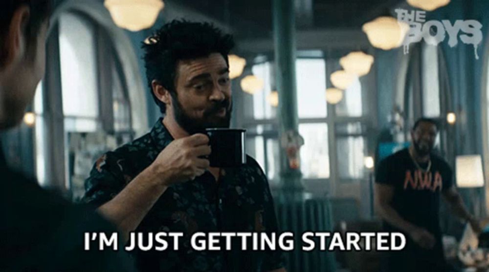 a man drinking a cup of coffee and saying i 'm just getting started