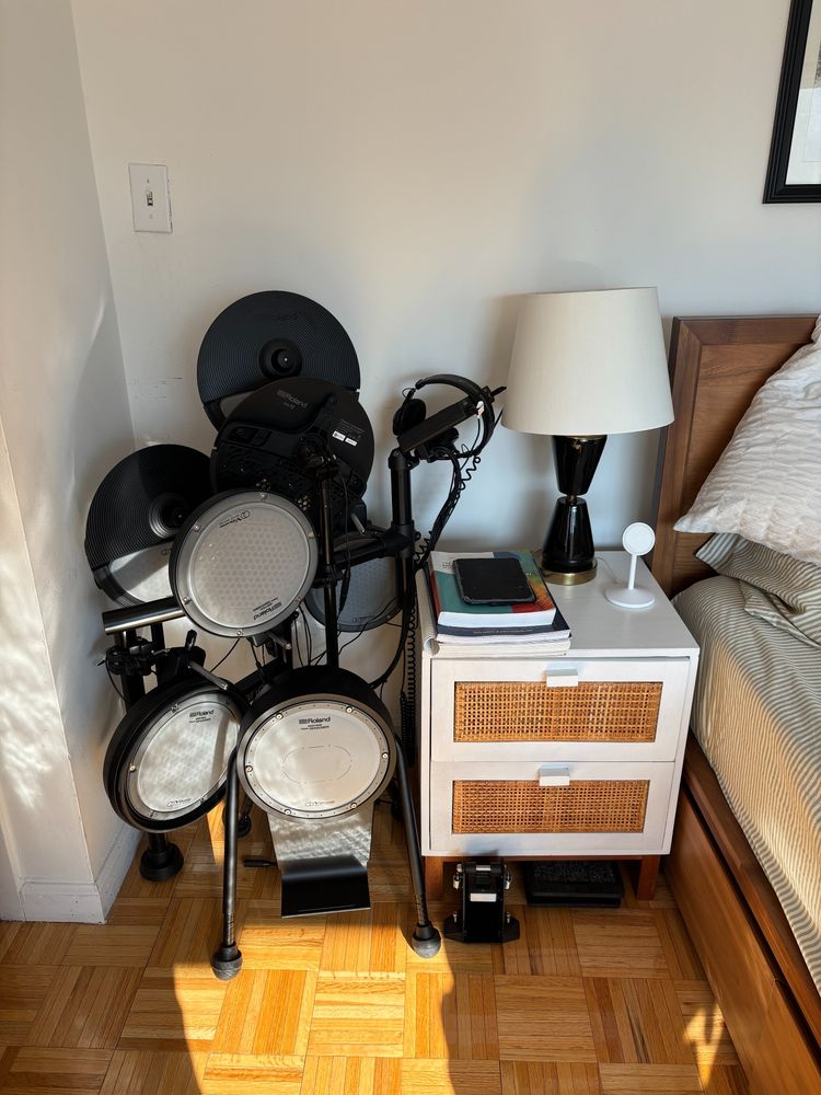 The combined drumset folded up (larger) next to my nightstand.