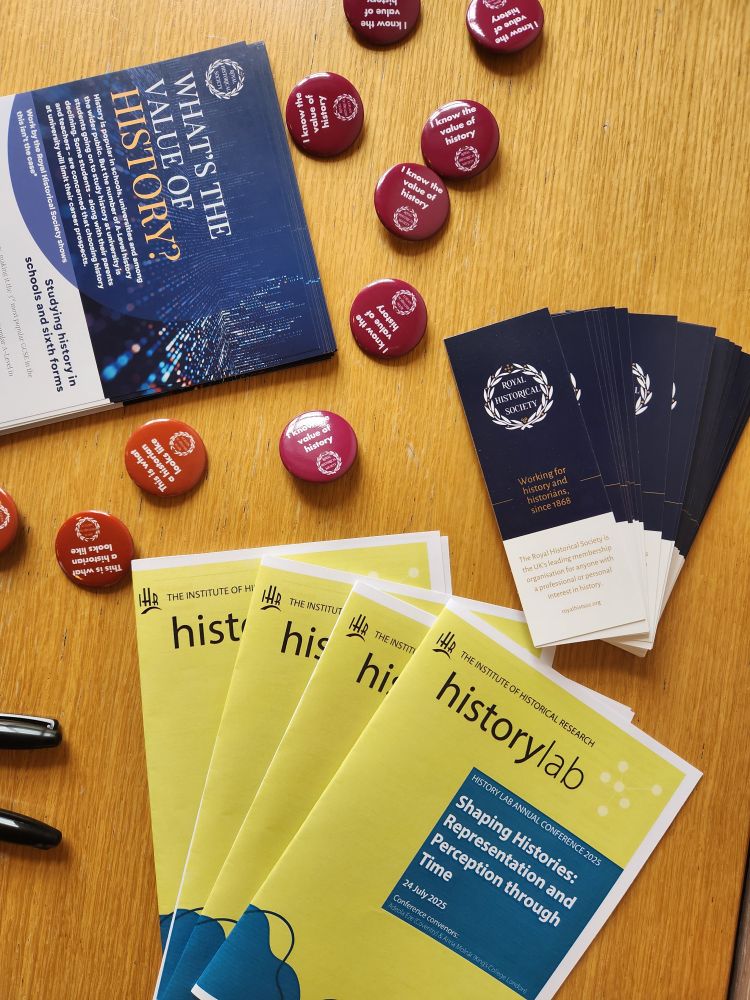 Photograph of History Lab conference programmes and Royal Historical Society bookmarks, leaflets and badges. 