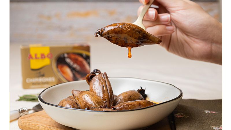 A dish of canned calamari, cooked in its own ink.